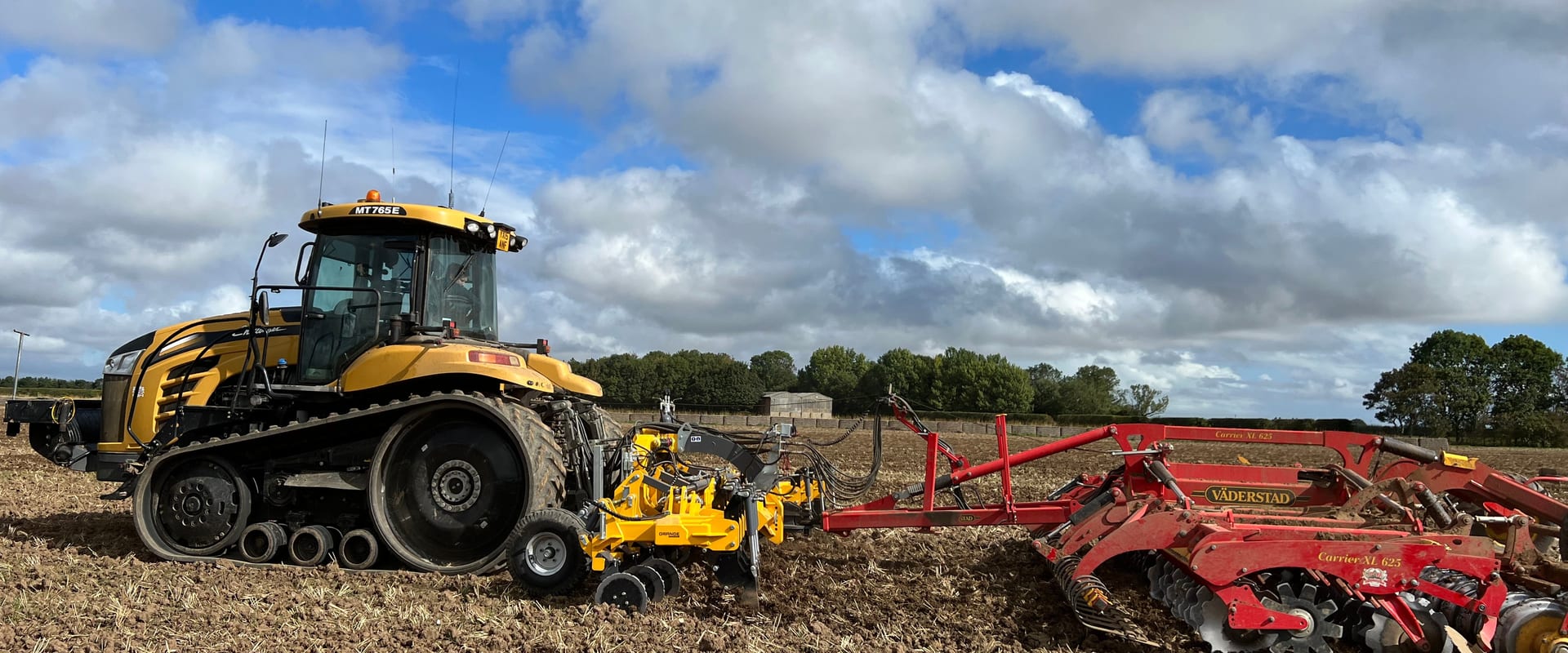Tractor wide implement field working aerial view UK agriculture